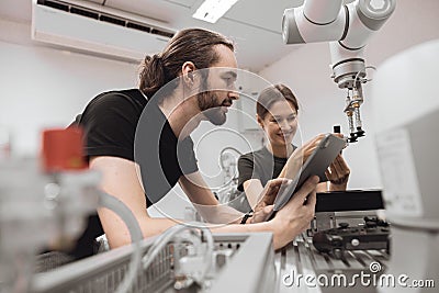 Industrial Robotics program university students learning education mechanical assembly with Robot Universal Training Platform Stock Photo
