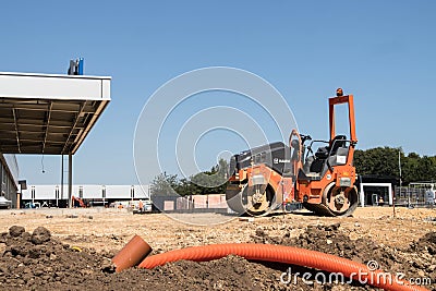 Industrial roller machine parked on construction site Editorial Stock Photo
