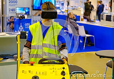 Industrial simulator of the airplane ladder driving is demonstrated at the exhibition Editorial Stock Photo