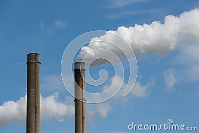 Industrial smoke stacks of a power plant. Stock Photo