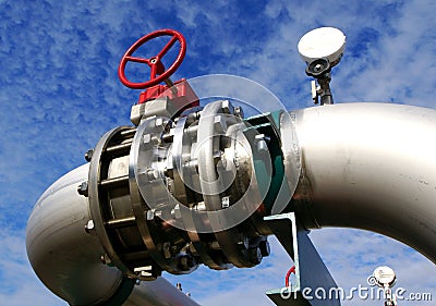 Industrial stainless Steel pipelines and valves against blue sky Stock Photo