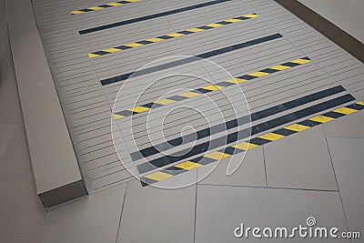 Industrial striped road or step warning on grey ramp for handicap or wheelchair. Stock Photo