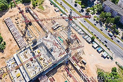 Industrial tower crane standing high at city construction site. aerial view Stock Photo