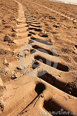 Industrial tractor footprint on beach sand Stock Photo