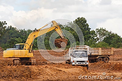 Industrial truck loader excavator moving earth and unloading int Stock Photo