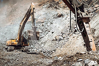 Industrial type excavator digging at a quarry or a construction site Stock Photo
