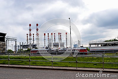 Industrial urban landscape. Train and smokestacks in the background of a stormy sky Stock Photo