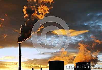 Industrial view. golden smoke from factory during sunset Stock Photo