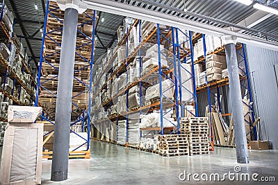 Industrial warehouse and logistics concept. Large storage with racks, shelves, boxes, containers and other goods Stock Photo
