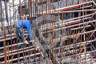 Industrial welding worker for steel work construction in area building with Welding process by Shielded Metal Arc Welding Stock Photo