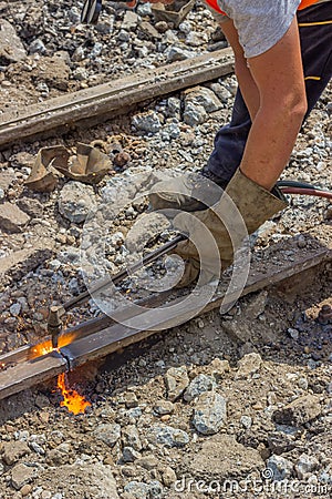 Industrial worker cutting a old tram tracks with an oxy-acetylene torch Stock Photo