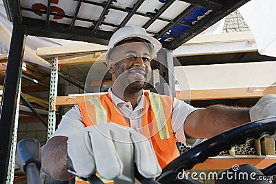 Industrial Worker Driving Forklift At Workplace Stock Photo