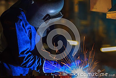 Industrial worker is welding in construction plant Stock Photo