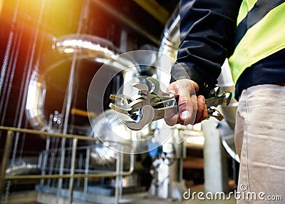 Industrial worker with spanner at factory workshop Stock Photo