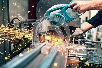 Industrial worker using a compound mitre saw with sharp blade Stock Photo