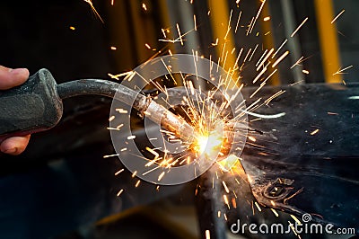 Industrial worker welding metal in steel factory Stock Photo