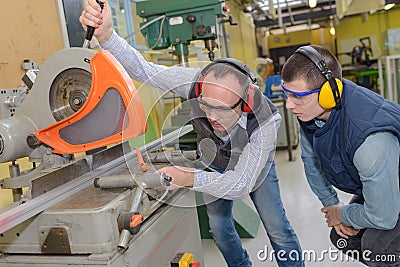 Industrial workers using metal cutter machine Stock Photo