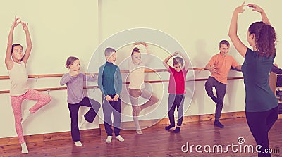 Industrious boys and girls rehearsing ballet dance in studio Stock Photo