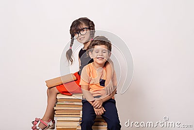 Industrious child boy and girl with books. Back to school creative background with school children. Stock Photo
