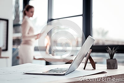 Industrious clever businesswoman heading to her laptop having new idea Stock Photo