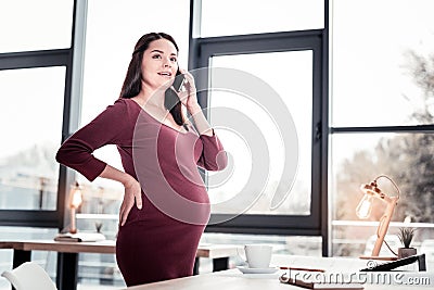 Industrious skillful journalist calling taxi from office while heading home Stock Photo