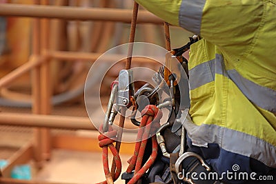 Industry abseiler worker working at height abseiling removing rope from chest harness croll safety device Stock Photo