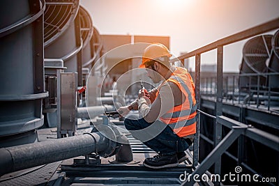 Industry engineer under checking the industry cooling tower air conditioner is water cooling tower air chiller HVAC of large indus Stock Photo