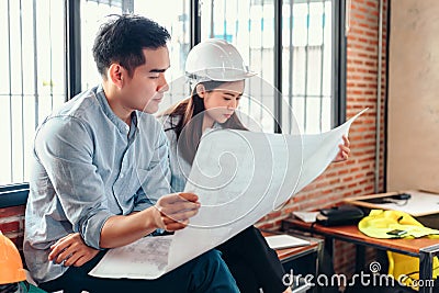 Industry manager and engineer, businessman reading and checking blueprint, drawing in the room Stock Photo