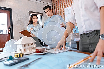 Industry manager and engineer, businessman reading and checking blueprint, drawing in the room Stock Photo
