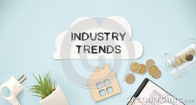 INDUSTRY TRENDS text on paper with calculator, with coins, flower. Stock Photo