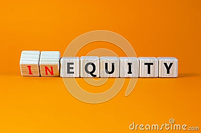 Inequity or equity symbol. Turned wooden cubes and changed the word inequity to equity. Business and inequity or equity concept. Stock Photo