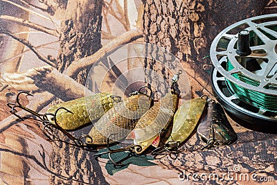 Inertia fishing reel with oscillating old USSR lures Stock Photo