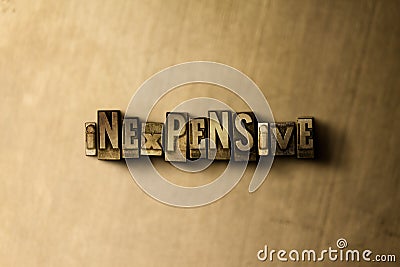 INEXPENSIVE - close-up of grungy vintage typeset word on metal backdrop Cartoon Illustration