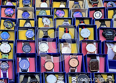 Inexpensive unbranded wrist watches kept on table for sale in a Inidan market Editorial Stock Photo