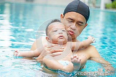 Infant adorable child boy swimming with father Stock Photo
