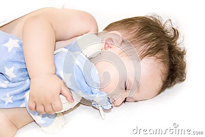 Infant baby boy sleeping. baby sleeping with her teddy bear, new family and love concept Soft focus and blurry . Healthy child, sw Stock Photo