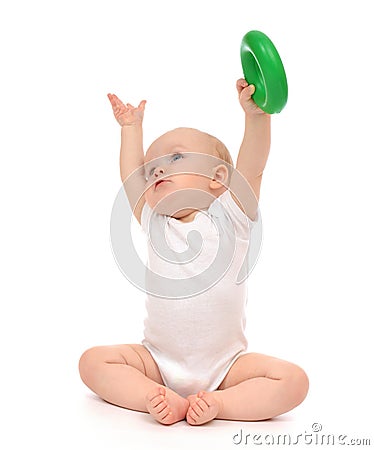 Infant child baby boy toddler playing holding green circle in ha Stock Photo