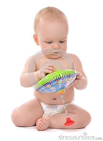 Infant child baby boy toddler playing with whirligig toy Stock Photo