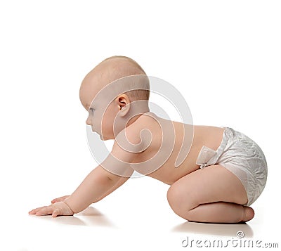 Infant child baby girl learning how to crawl in diaper looking a Stock Photo