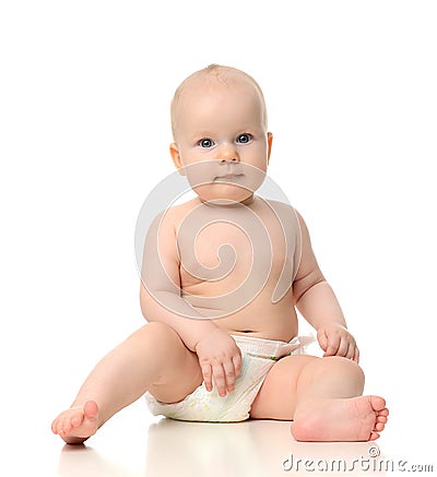 Infant child baby girl toddler sitting in diaper looking a Stock Photo
