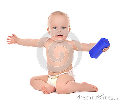 Infant child baby girl toddler sitting and eating blue toy Stock Photo