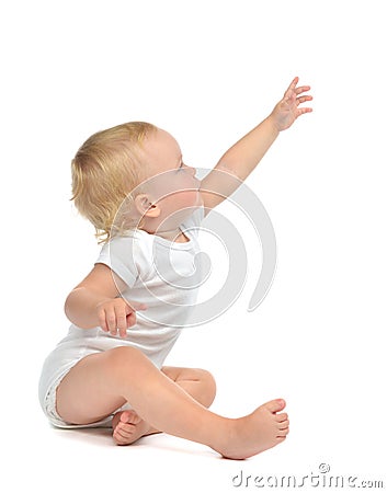 Infant child baby toddler sitting raise hand up pointing finger Stock Photo