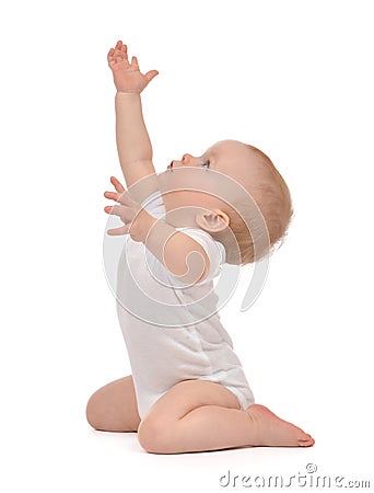 Infant child baby toddler sitting raise hands up Stock Photo