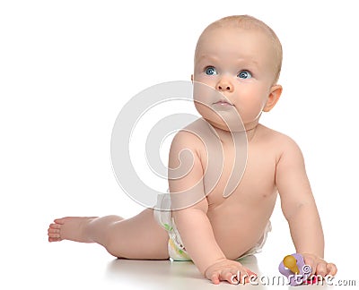 Infant child girl lying happy holding baby nipple soother Stock Photo