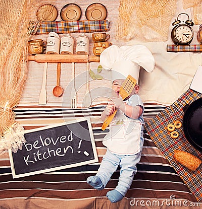 Infant cook baby boy portrait wearing apron and chef hat Stock Photo