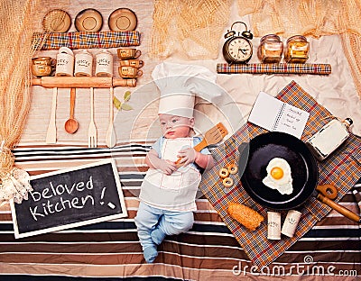 Infant cook baby boy portrait wearing apron and chef hat Stock Photo