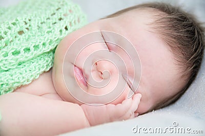 Infant cute baby sleeping portrait lying on arms Stock Photo