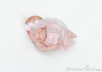 Infant dressed in pink laced costume napping tightly Stock Photo