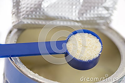 Infant formula in spoon and can Stock Photo