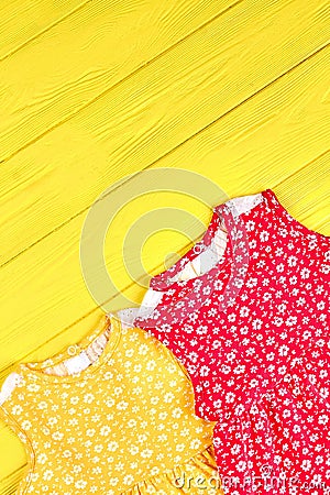 Infant girl colored patterned dresses. Stock Photo